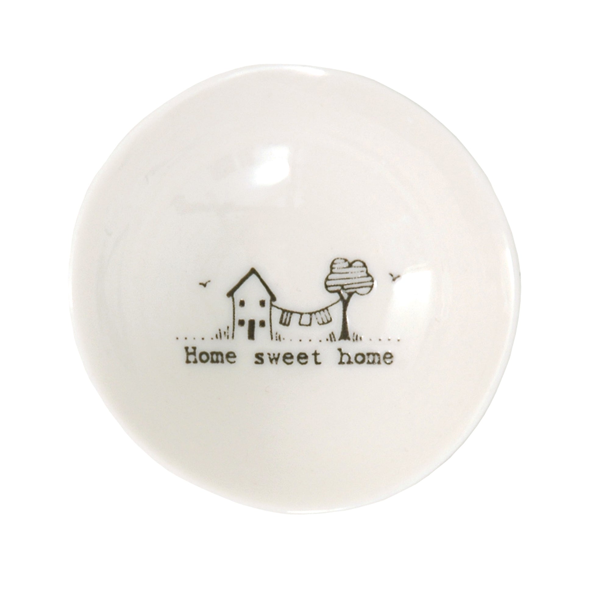 A white ceramic trinket bowl featuring a house & tree illustration and a quote