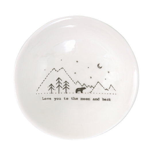 A white ceramic bowl featuring a bear in the mountains illustration and a quote