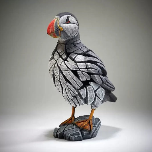 A textured and painted puffin figure sculpture