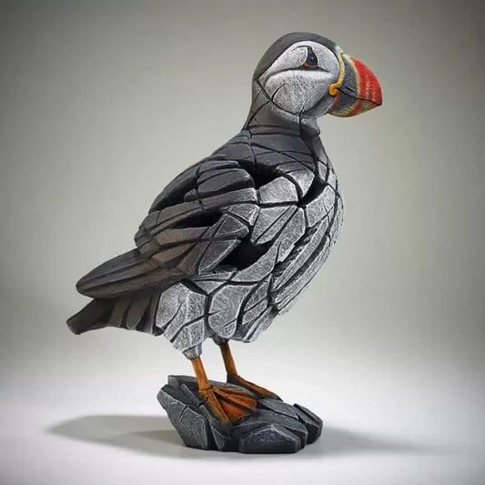 A textured and painted puffin figure sculpture side view