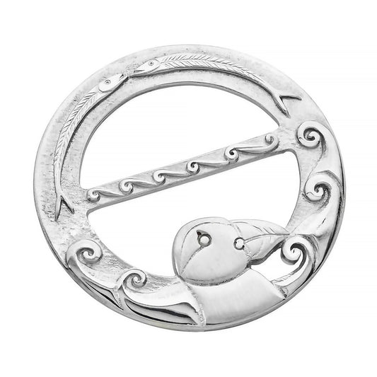 A round pewter brooch featuring a puffin with waves design and two fish