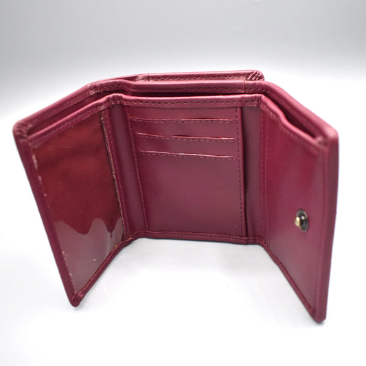 Inside of a tri-fold purple faux leather purse 