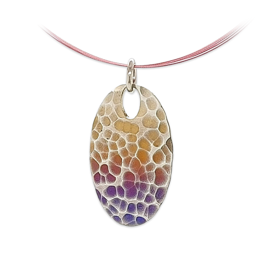 An oval pendant with yellow and purple ripple design pattern