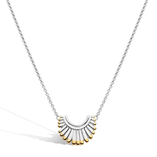 A silver necklace with a fan shaped pendant and yellow gold details