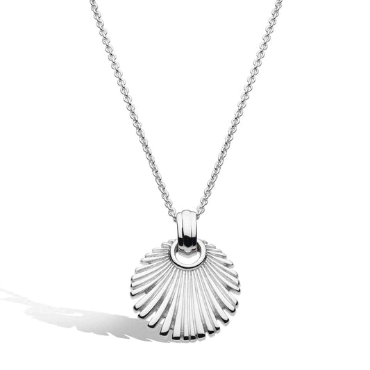 A silver necklace with a round fan shaped pendant