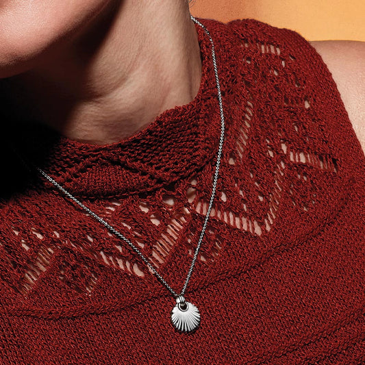 Model wearing a silver necklace with a round fan shaped pendant
