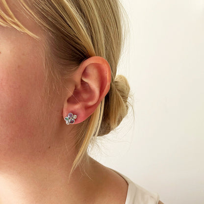 Model wearing multicolour CZ cluster silver stud earrings