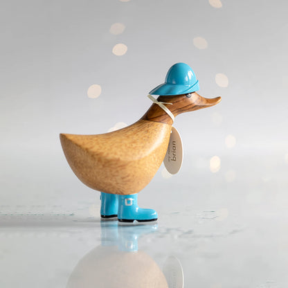 Wooden duck collectible figure in blue rain hat and boots
