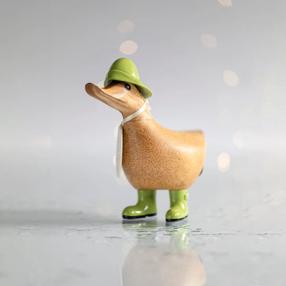 Wooden duck collectible figure in green rain hat and boots