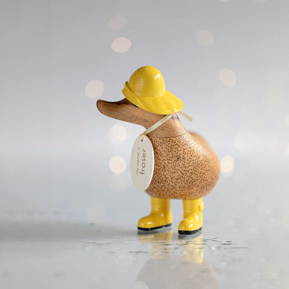 Wooden duck collectible figure in yellow rain hat and boots