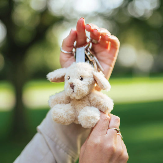 Model holding a plush labrador dog keyring