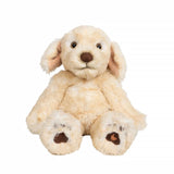 A stuffed labrador puppy plush toy with the Wrendale logo embroidered on the bottom of its foot