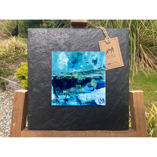 A tile mounted on slate featuring a textured painting of a water reflection on the West Coast of Scotland