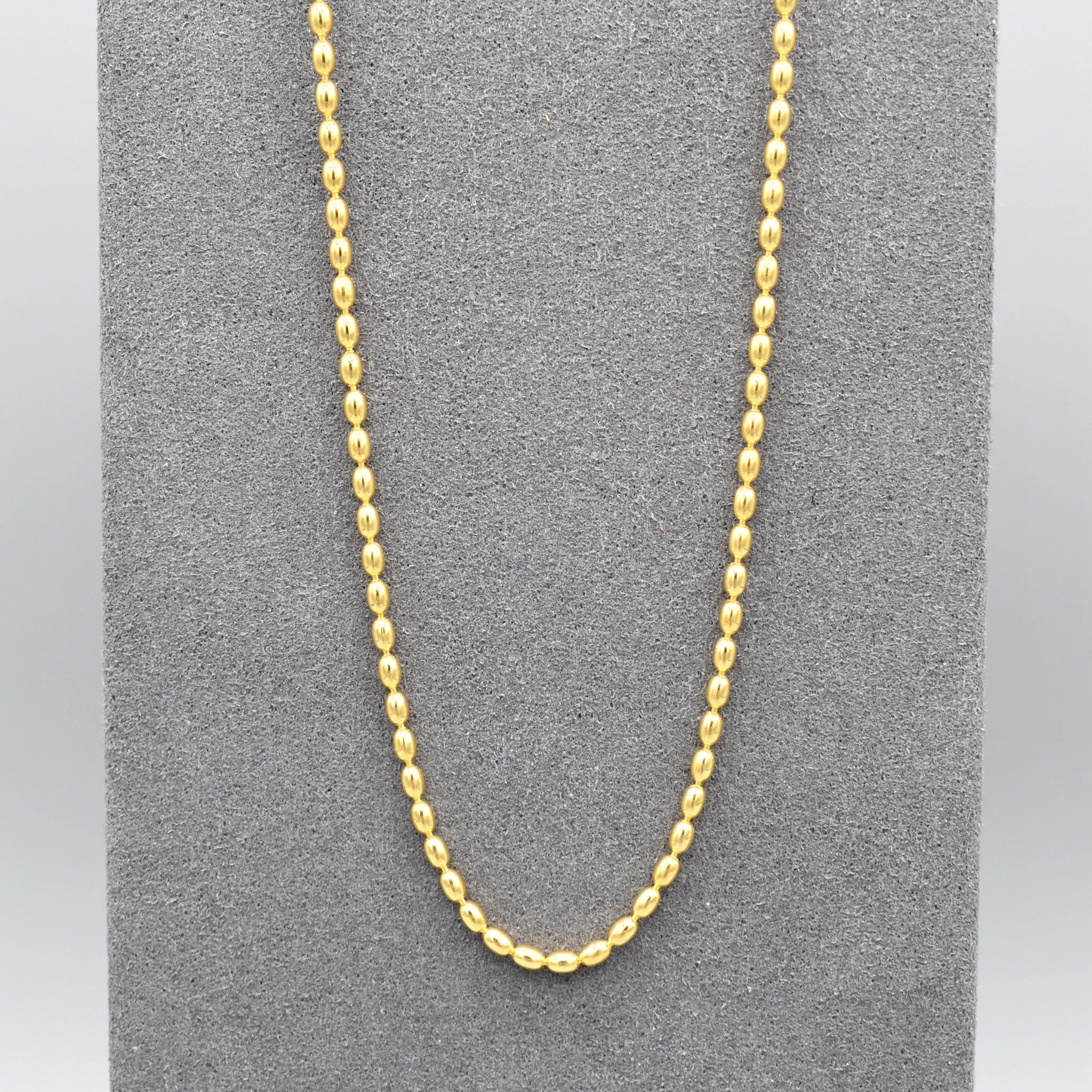 A rice shaped beaded chain necklace in yellow gold