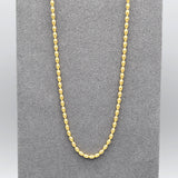 A rice shaped beaded chain necklace in yellow gold