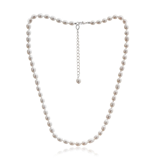 A silver lobster clasp necklace strung with small oval shaped white freshwater pearls
