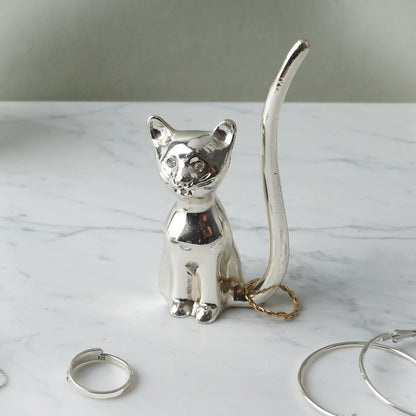 Shiny silver ring holder shaped like a cat with jewel eyes