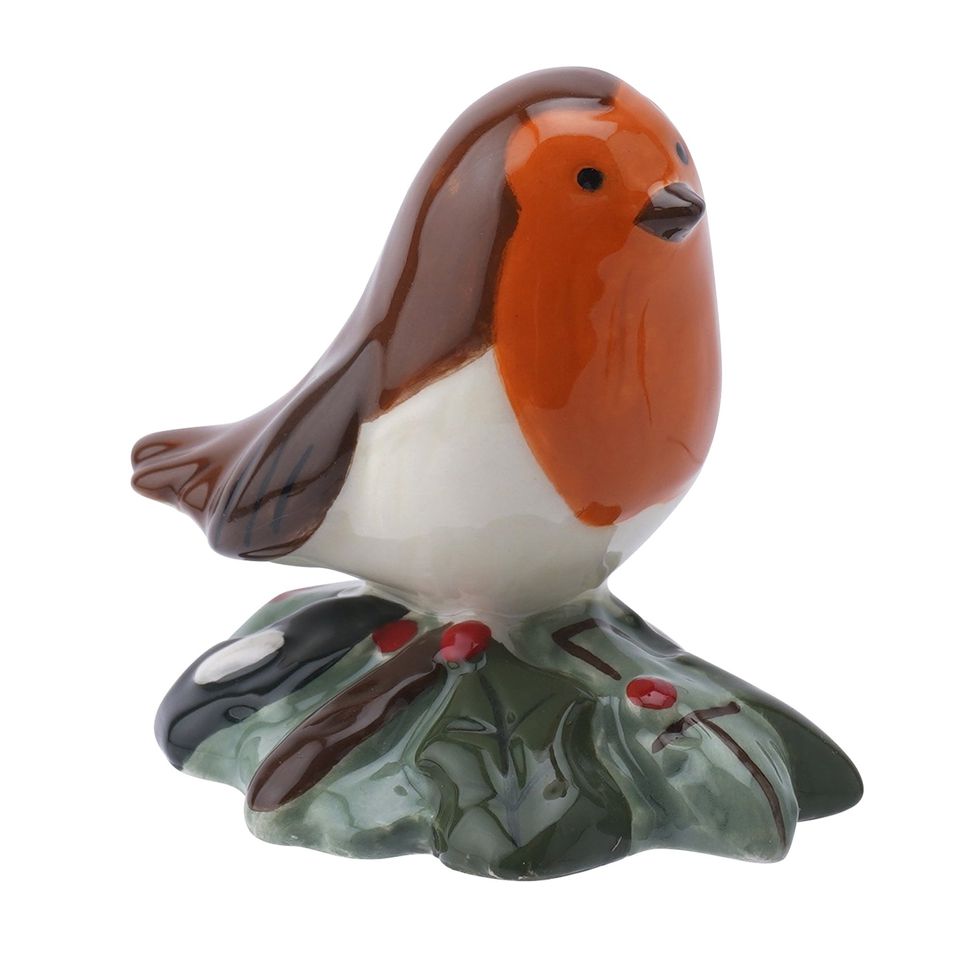 A glossy ceramic ornament of a little robin sitting on a holly bush