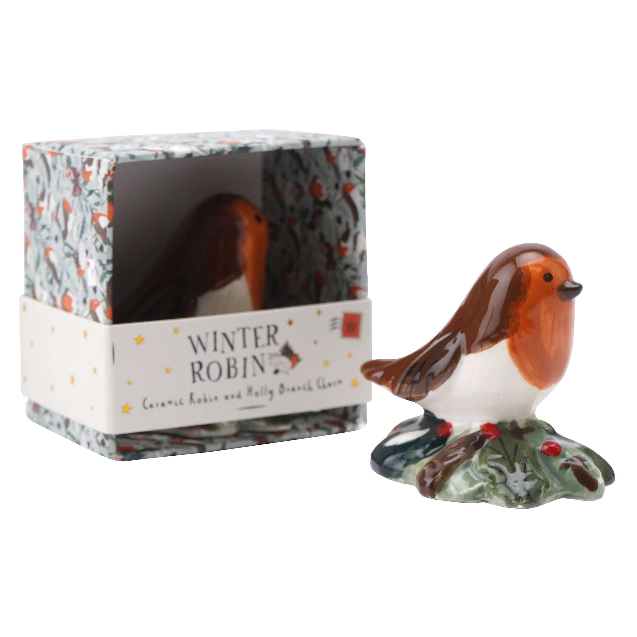 A glossy ceramic ornament of a little robin sitting on a holly bush with packaging