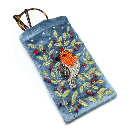 A dusky blue velvet glasses case with an embroidered and beaded robin and holly design