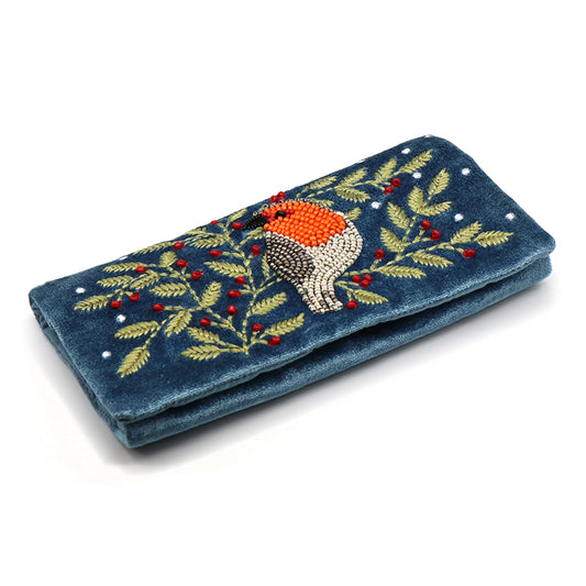 A dusky blue velvet jewellery roll with an embroidered and beaded robin and holly design