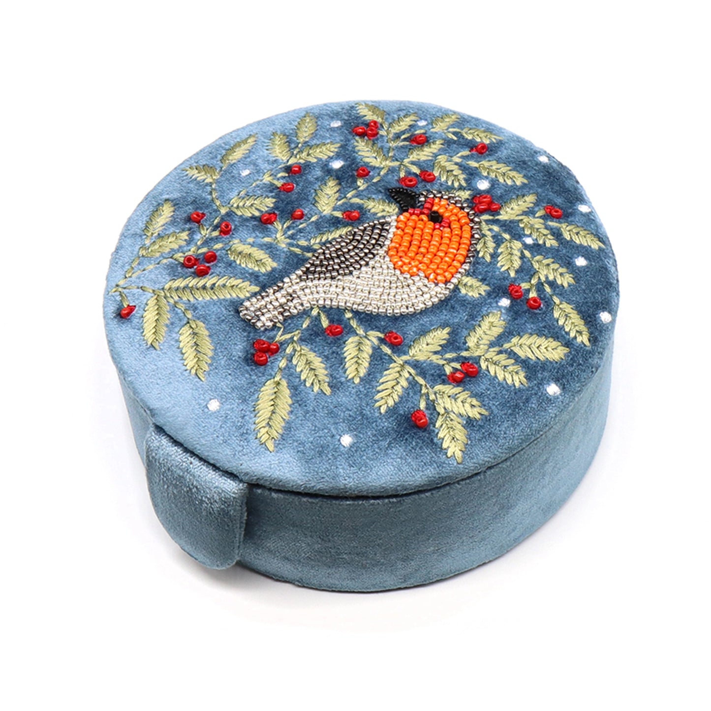 A round dusky blue velvet jewellery box with an embroidered and beaded robin and holly design