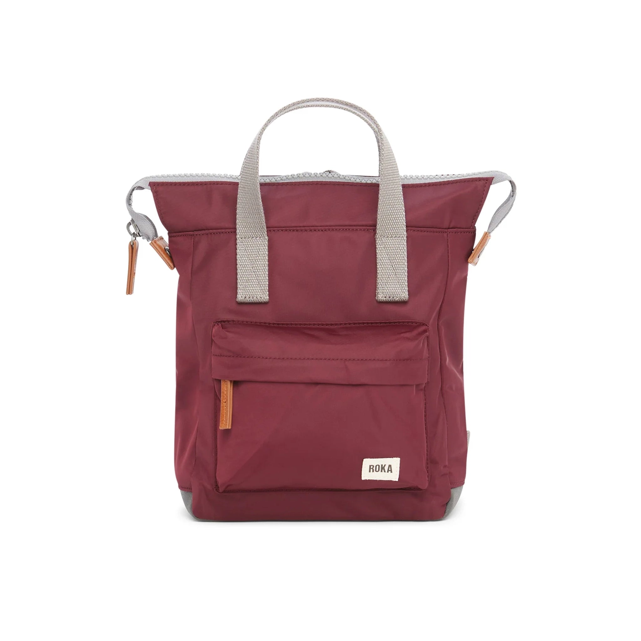 A nylon backpack in a plum red colour with grey handles and front zip pocket