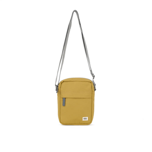 A small crossbody bag in canvas material and a flax yellow colour