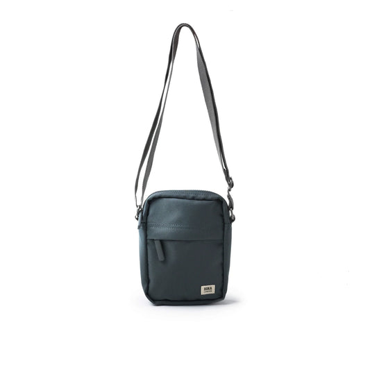 A small crossbody bag in canvas material and a smoke grey colour