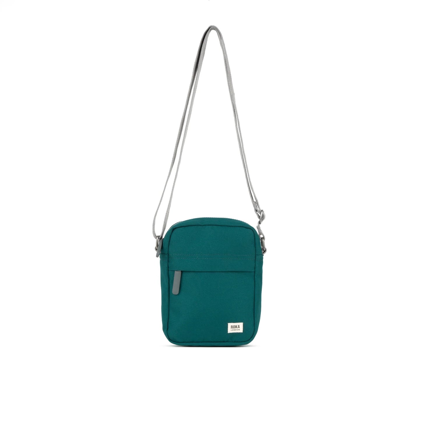 A small crossbody bag in canvas material and a teal colour