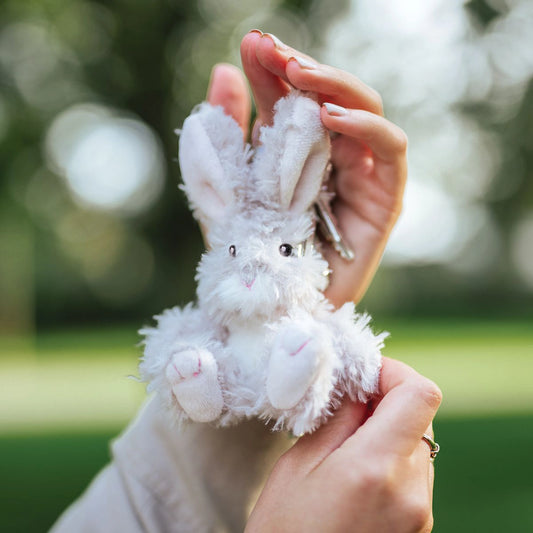 Model holding a plush bunny keyring