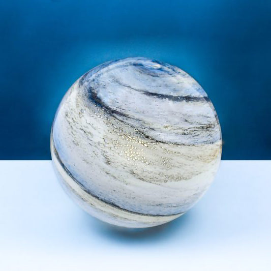 A glass orb light with swirling sand and blue colours