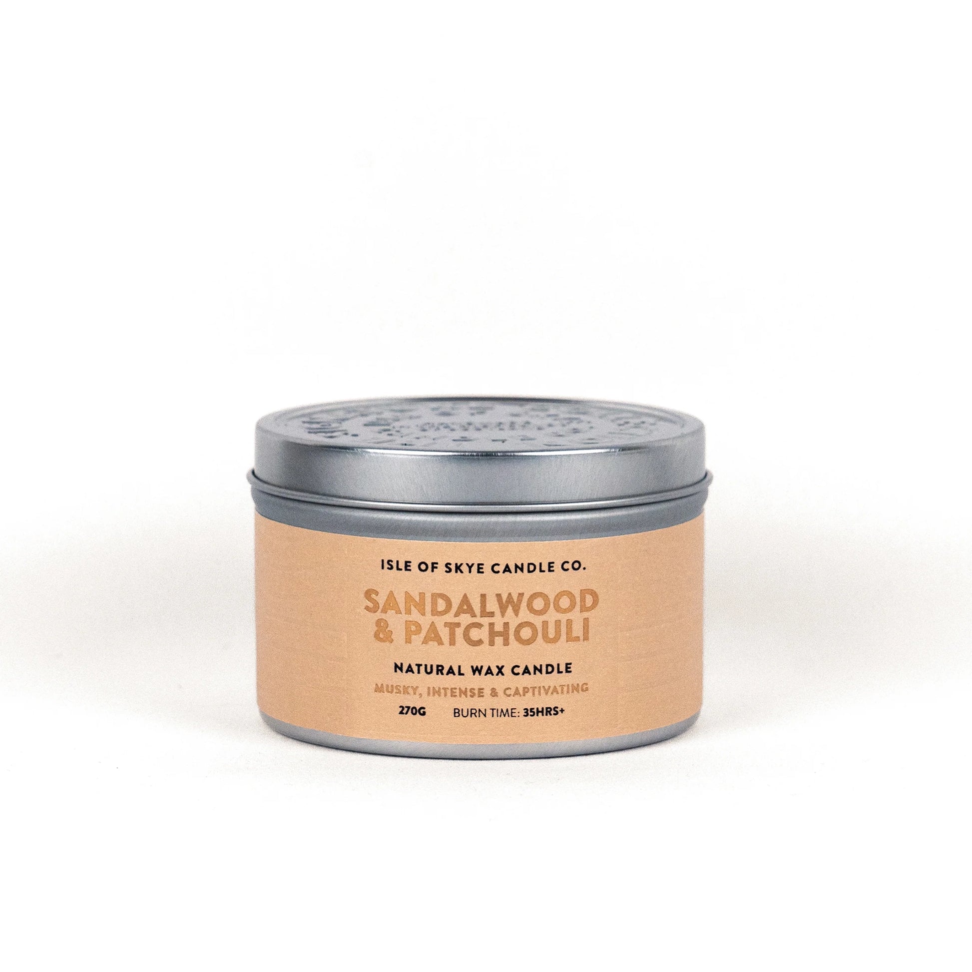 A travel tin candle in the scent sandalwood and patchouli