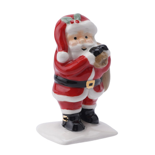 A ceramic red and white Santa carrying his present sack sculpture ornament 