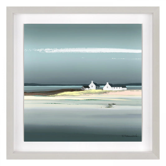 Square framed print of a seaside scene with blue sky and water and white cottages on a bright sandy shoreline.
