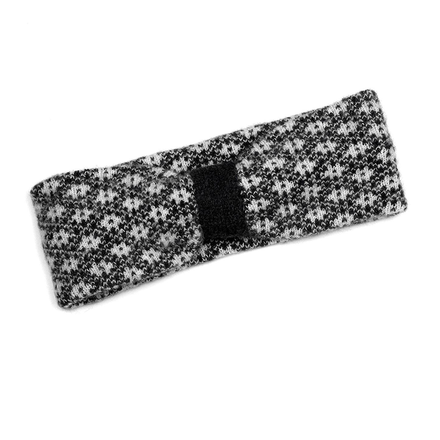 A black and white knitted headband with a floral Scandi style pattern