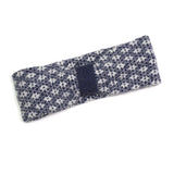 A denim and white knitted headband with a floral Scandi style pattern