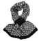 A knitted pull-through scarf with a black and white Scandi style floral design