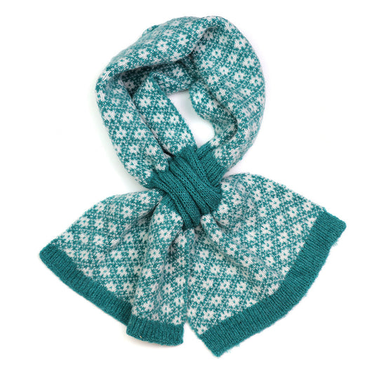 A knitted pull-through scarf with a green and white Scandi style floral design