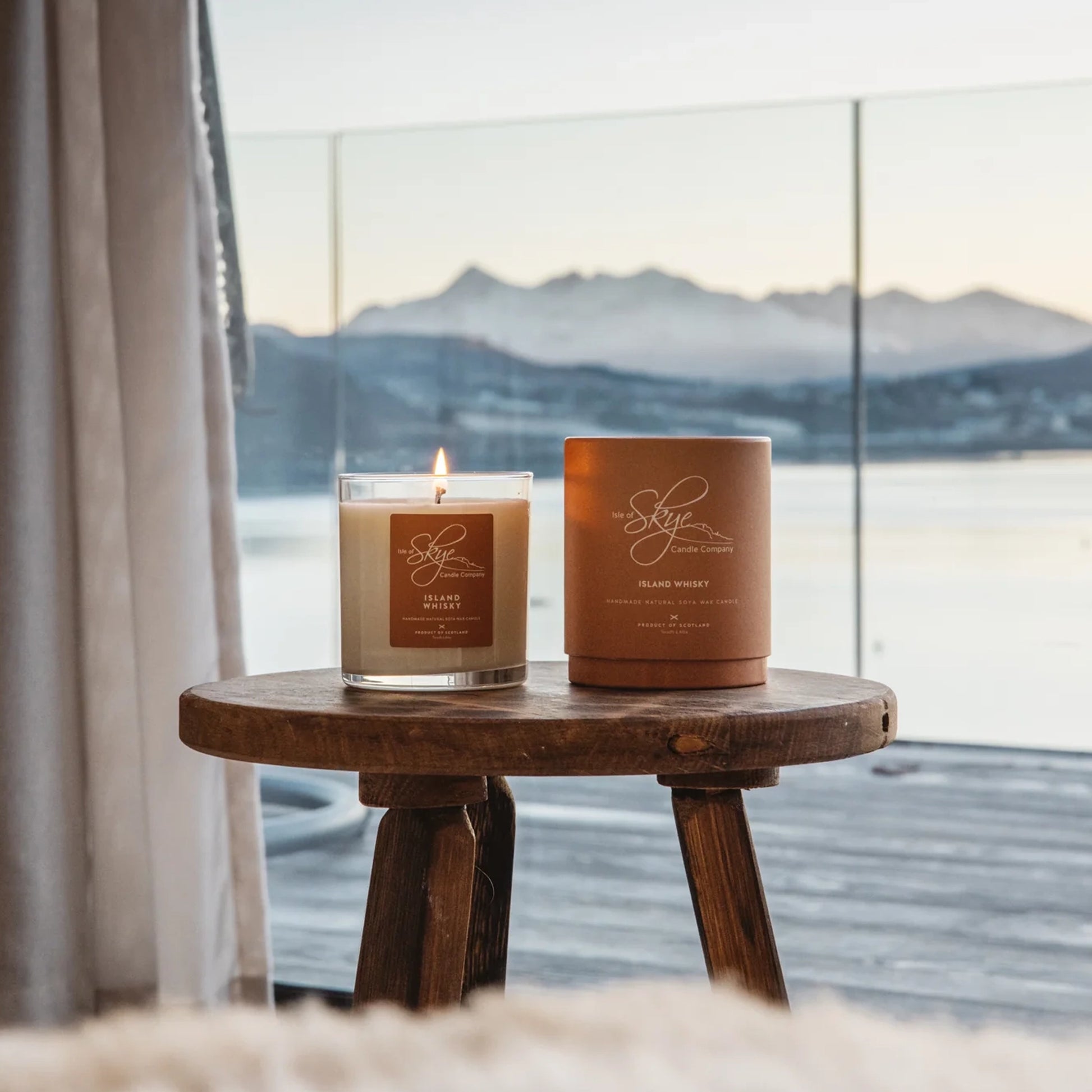 Island whisky scented candle in glass tumbler with tartan box lifestyle