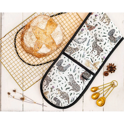 Cotton oven mitts with a Scottish wildlife design and black trim lifestyle