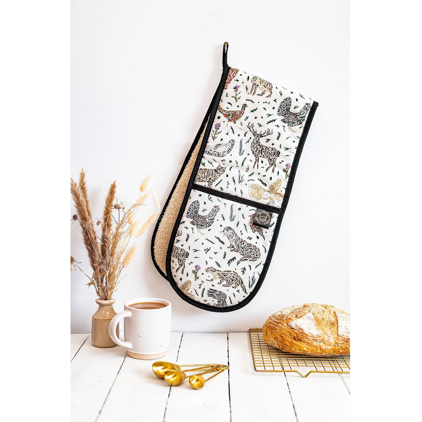 Cotton oven mitts with a Scottish wildlife design and black trim