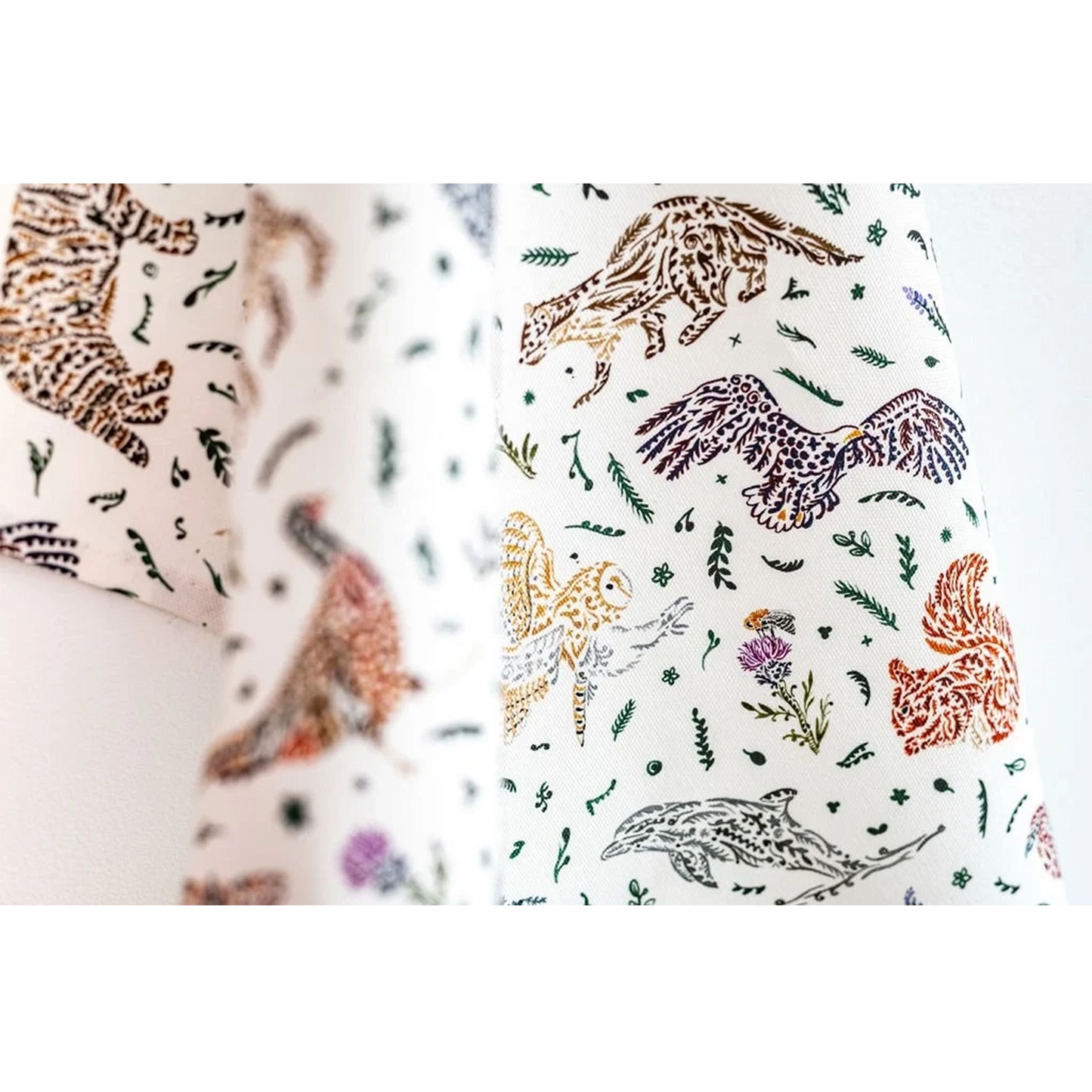 White cotton tea towel with Scottish wildlife design in florals detail