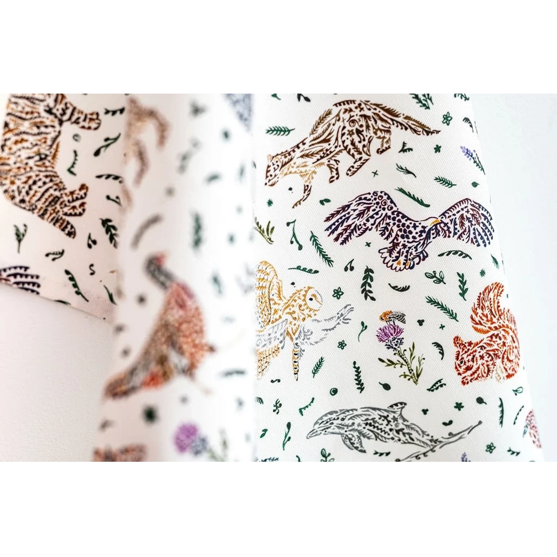 White cotton tea towel with Scottish wildlife design in florals detail