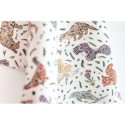 White cotton tea towel with Scottish wildlife design in florals detail
