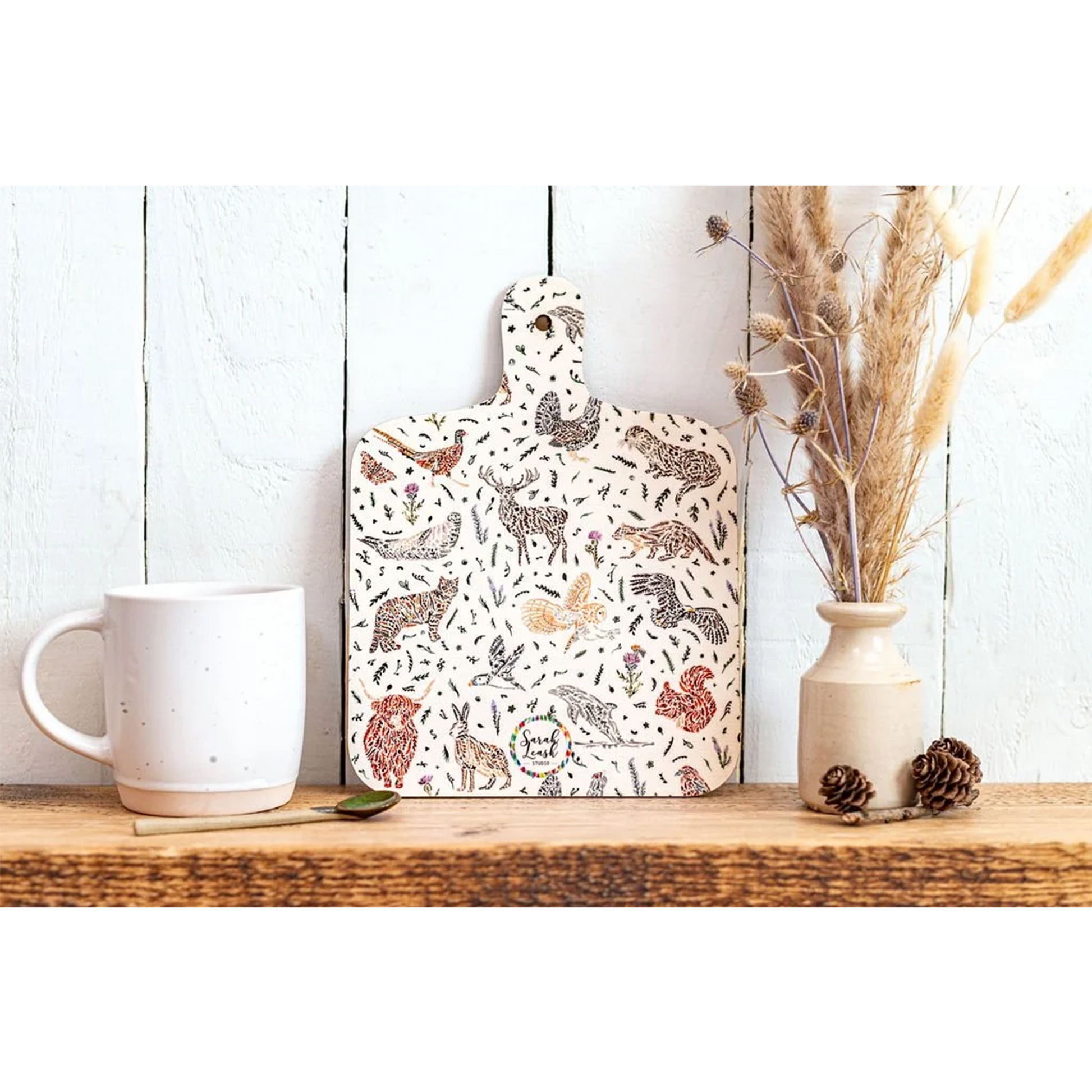 A double sided melamine chop board with a Scottish wildlife design back