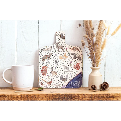 A double sided melamine chop board with a Scottish wildlife design front