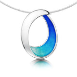 Large silver necklet with bright blue enamel in a simple abstract ocean wave shape on a silver neck wire