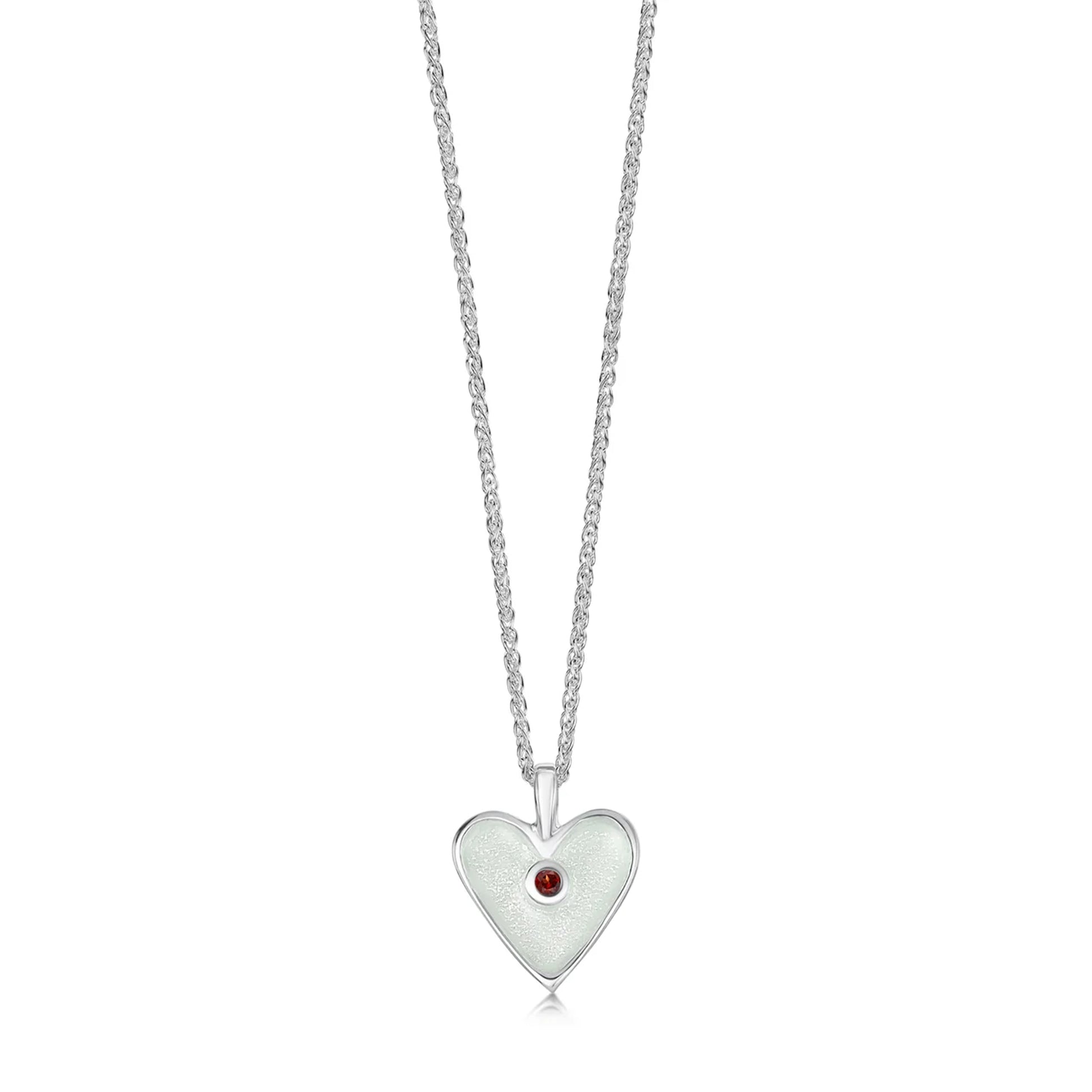Heart shaped silver pendant in white enamel with a red garnet stone in the centre and a silver chain
