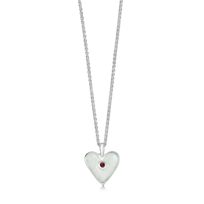 Heart shaped silver pendant in white enamel with a red garnet stone in the centre and a silver chain